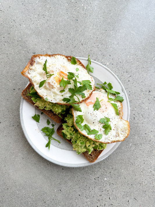 fried eggs with avocado and pea smash