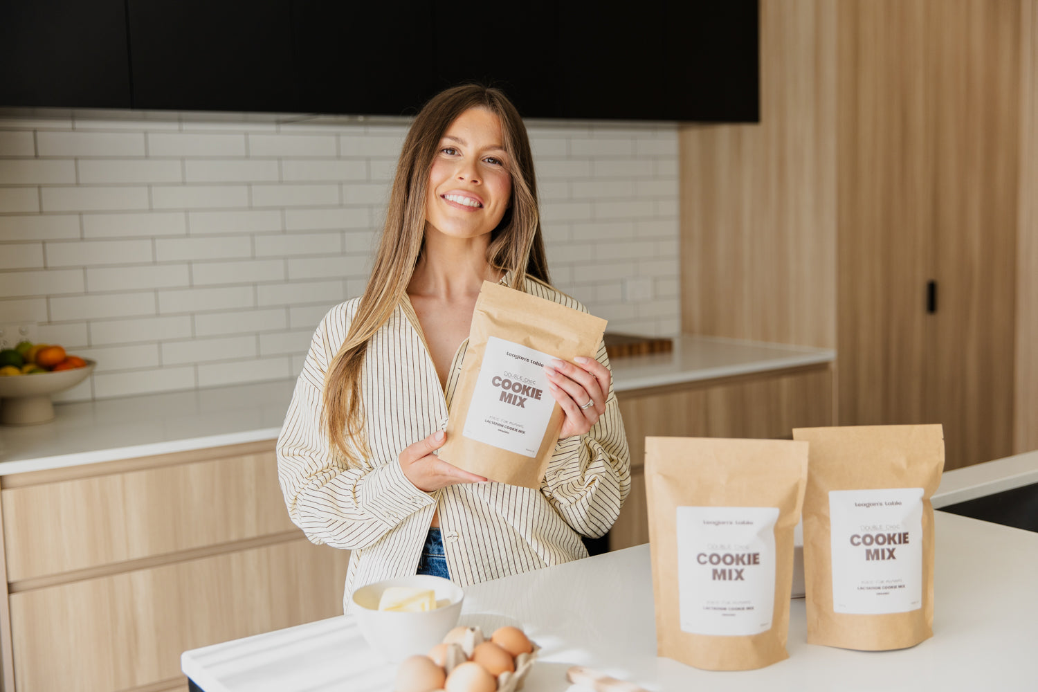 Teagan standing in kitchen holding cookie mix packaging