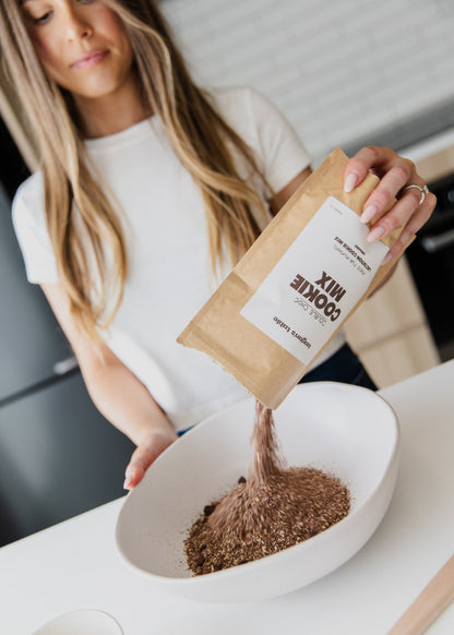 Teagan pouring cookie mix into bowl
